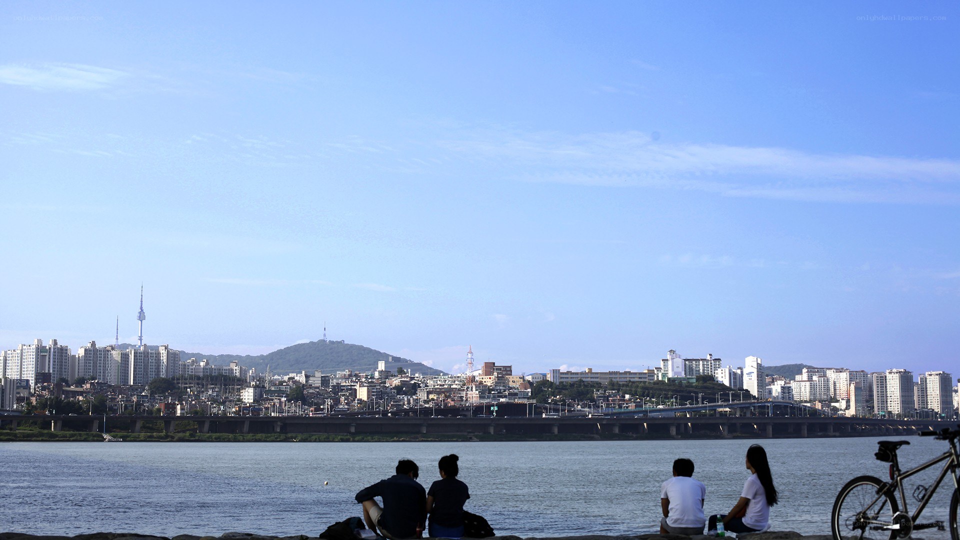People relaxing by the river