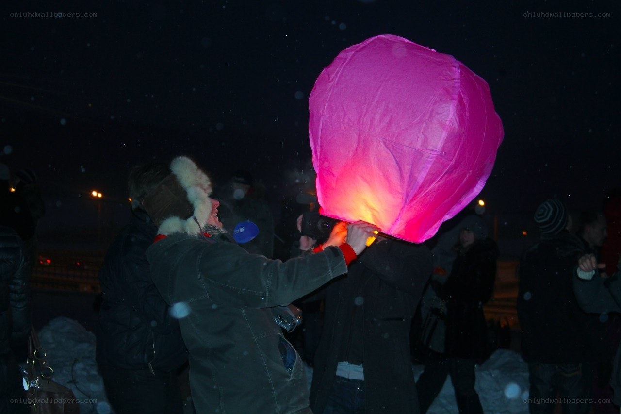 People releasing a sky lantern
