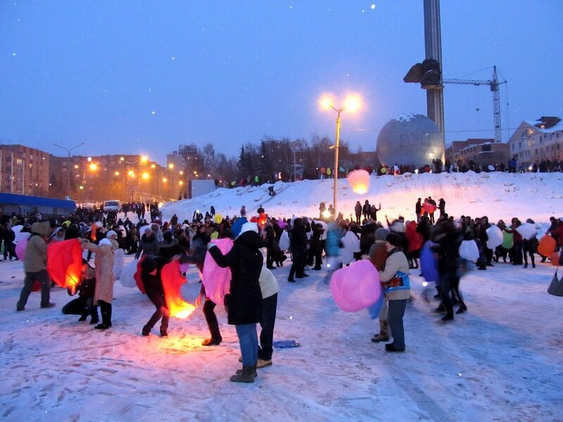 People releasing lanterns at night