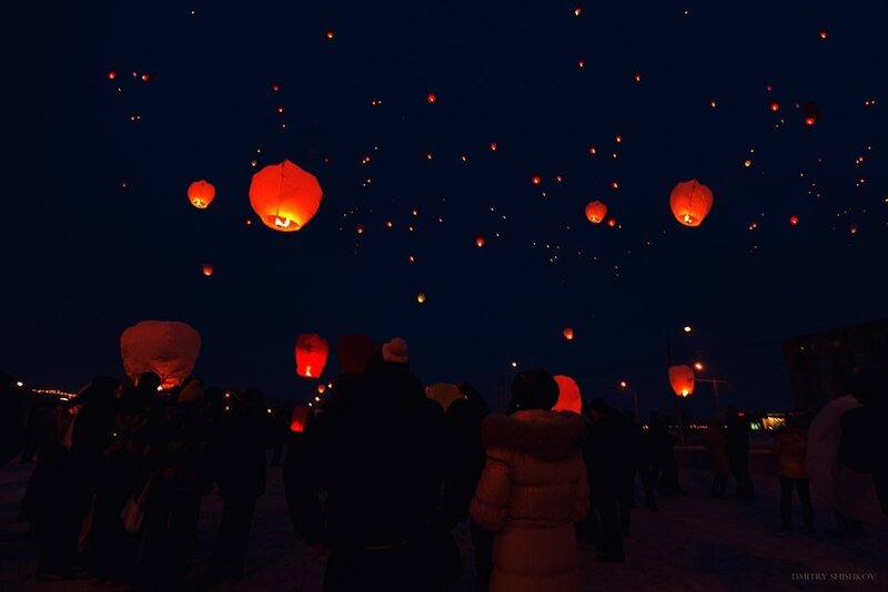 People Releasing Lanterns — Black, Serene