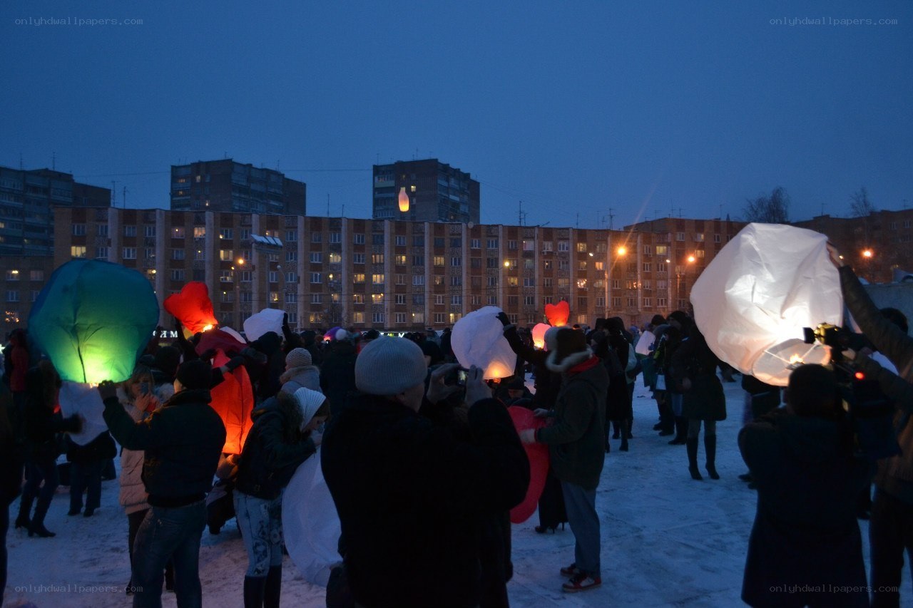 People releasing sky lanterns