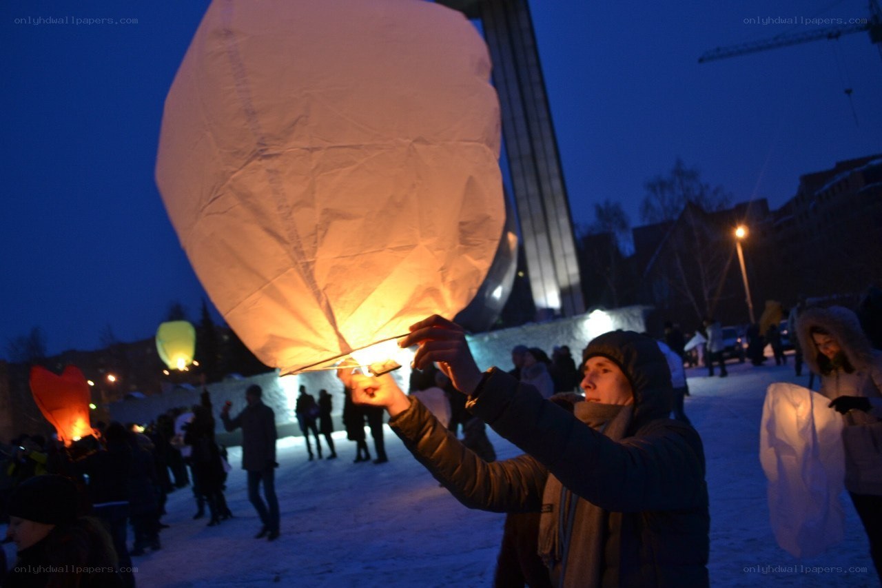 People releasing sky lanterns