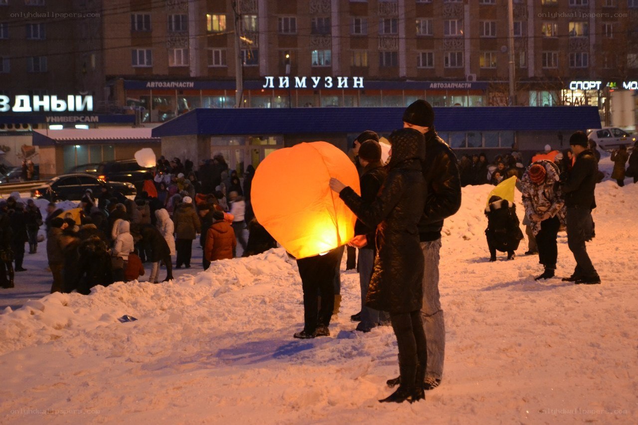 People releasing sky lanterns