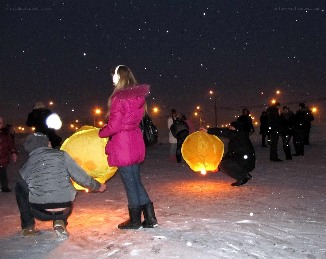 People releasing sky lanterns