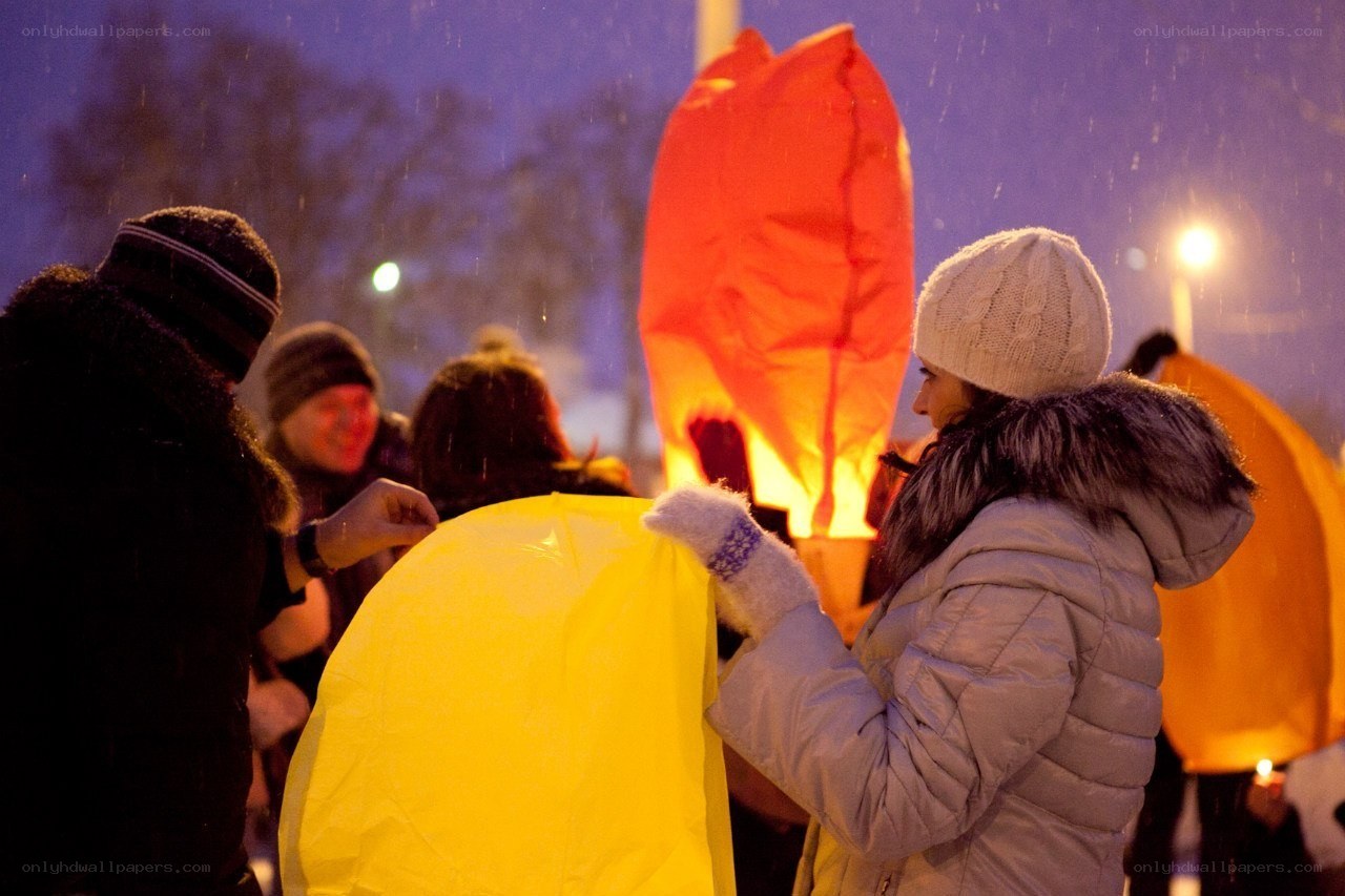 People releasing sky lanterns
