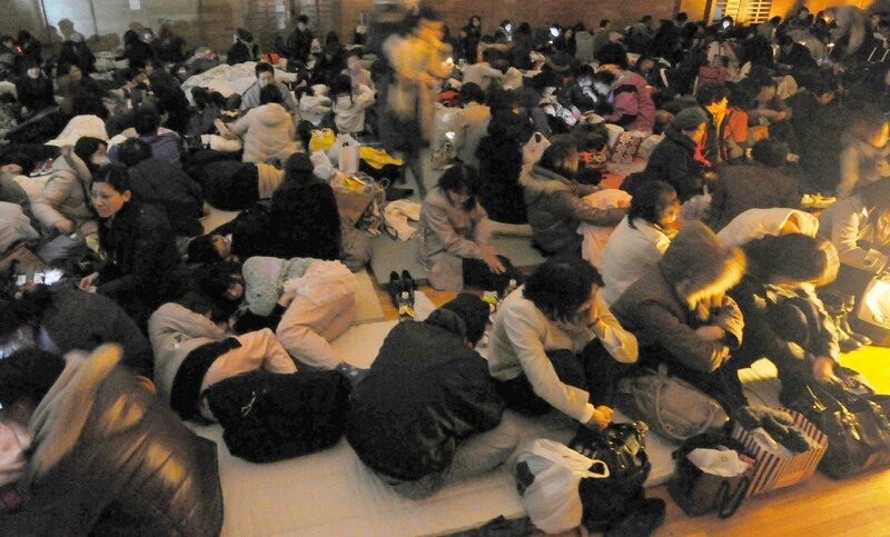 People resting in a crowded hall