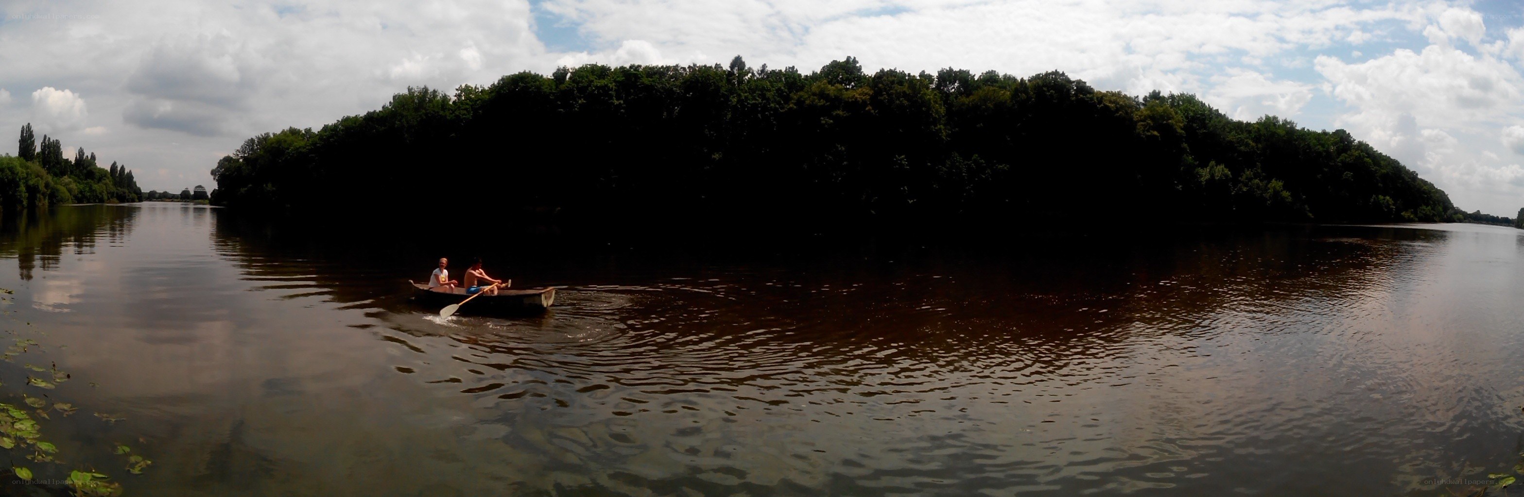 People rowing a boat on a river