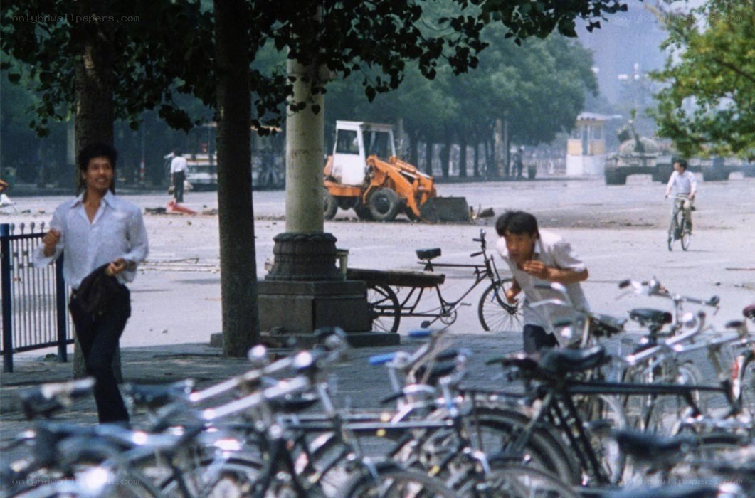 People running in a city square