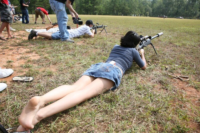 People shooting rifles in a field