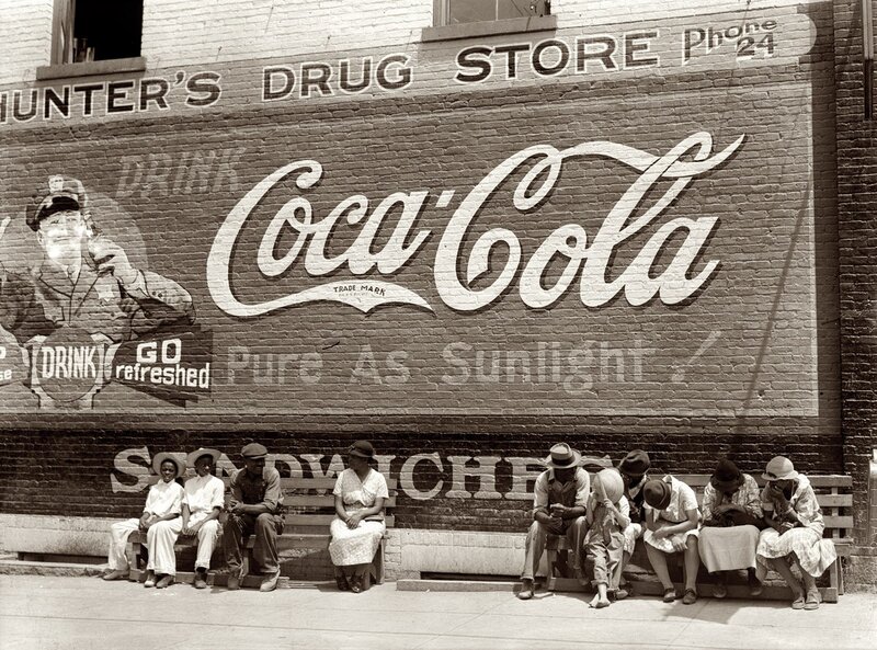 People sitting by drugstore