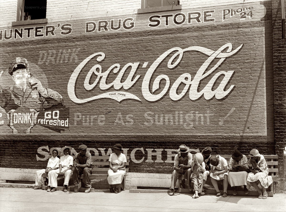 People sitting by drugstore
