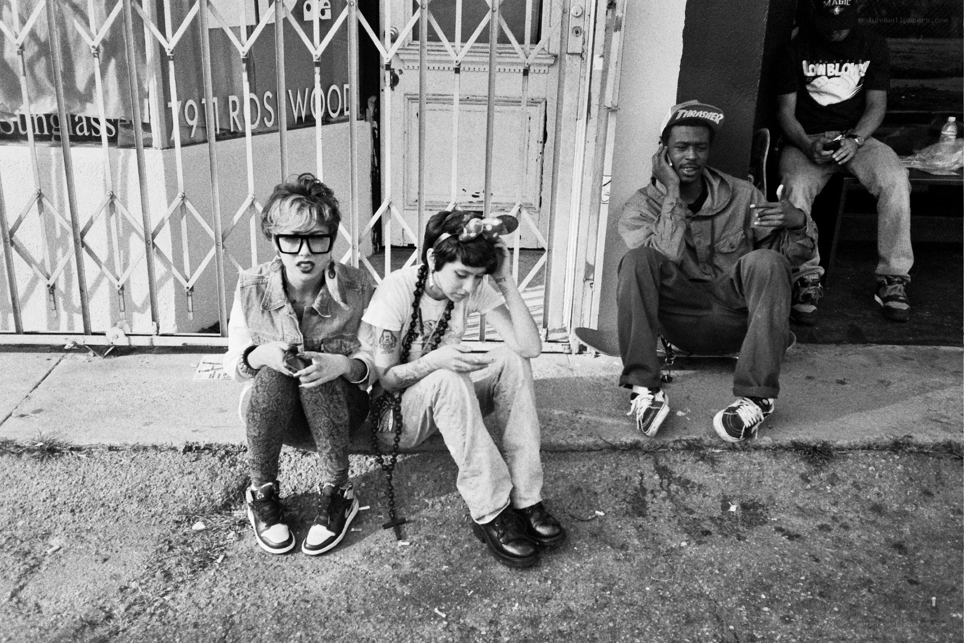 People sitting on a sidewalk