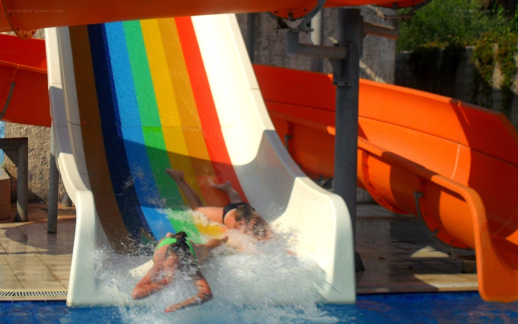 People sliding on water slide