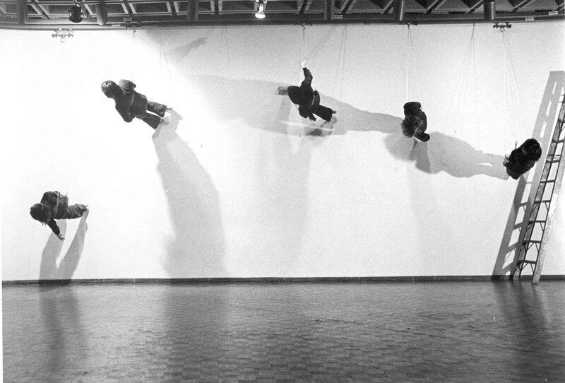 People suspended in art installation