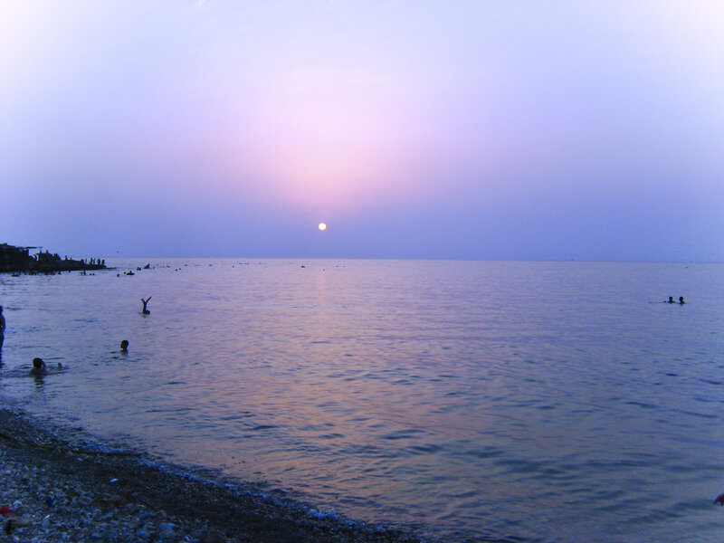 People Swimming at Sunset