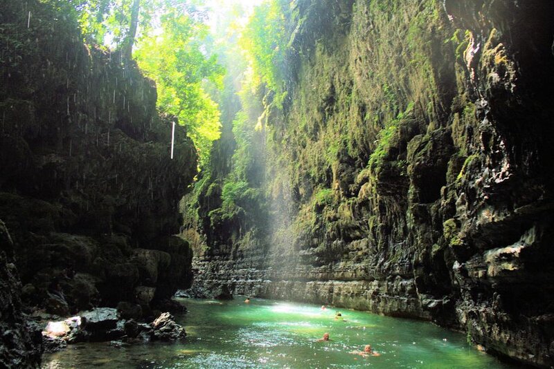 People swimming in a canyon pool