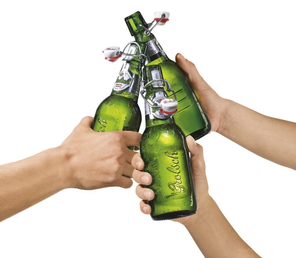 people toasting with beer bottles