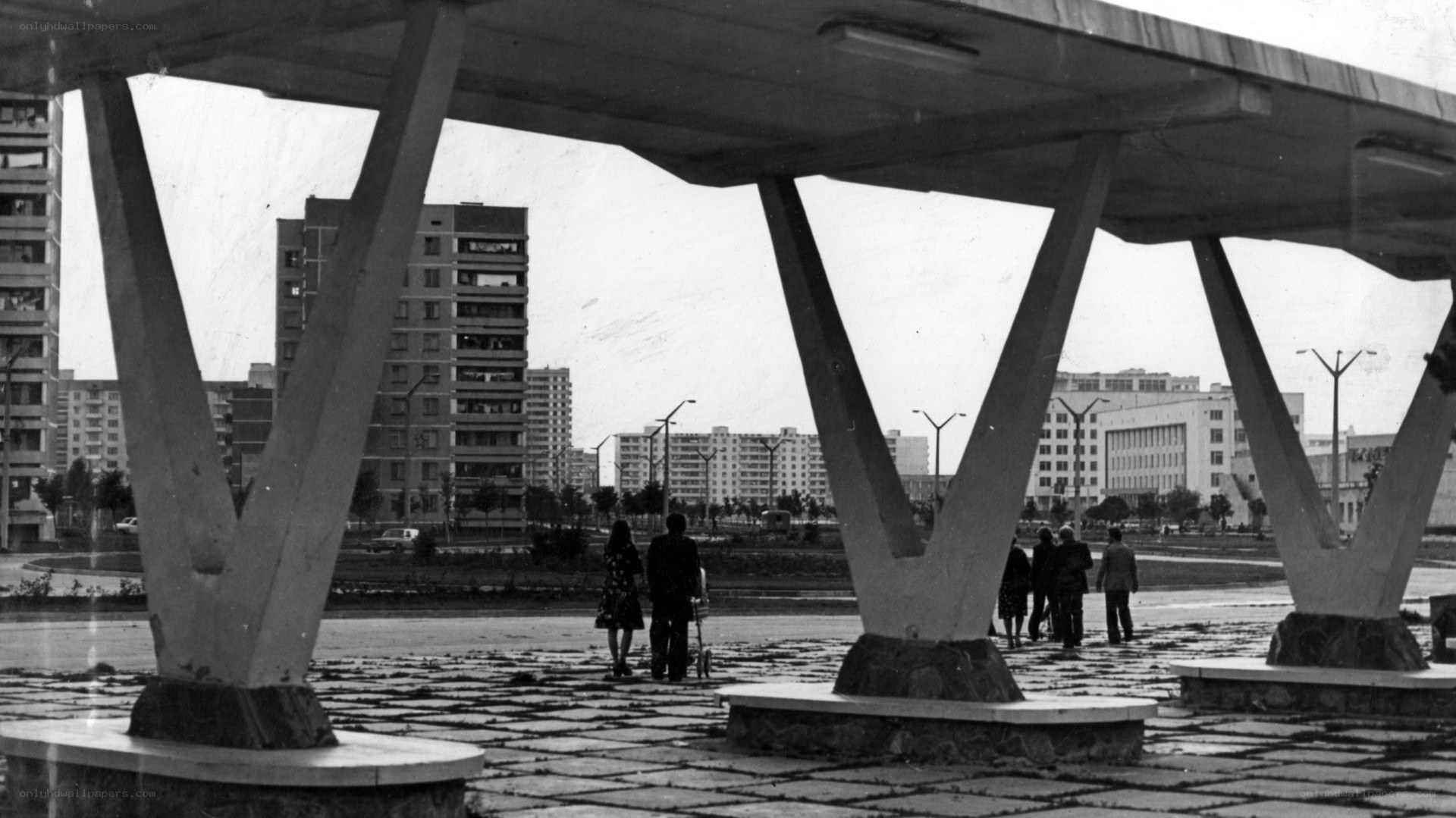 People under a modern structure