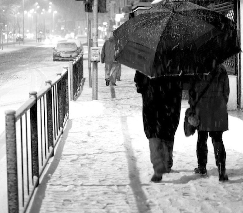 People under Umbrella in Snow