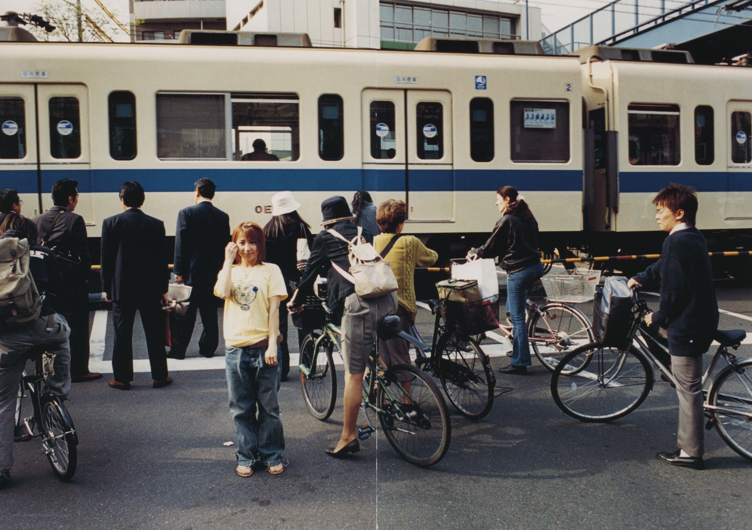 People waiting at a train crossing