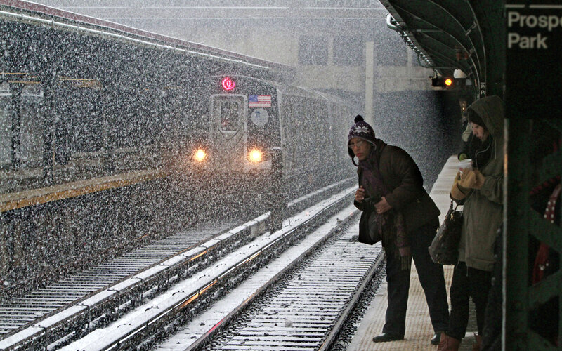 People waiting for train in snow