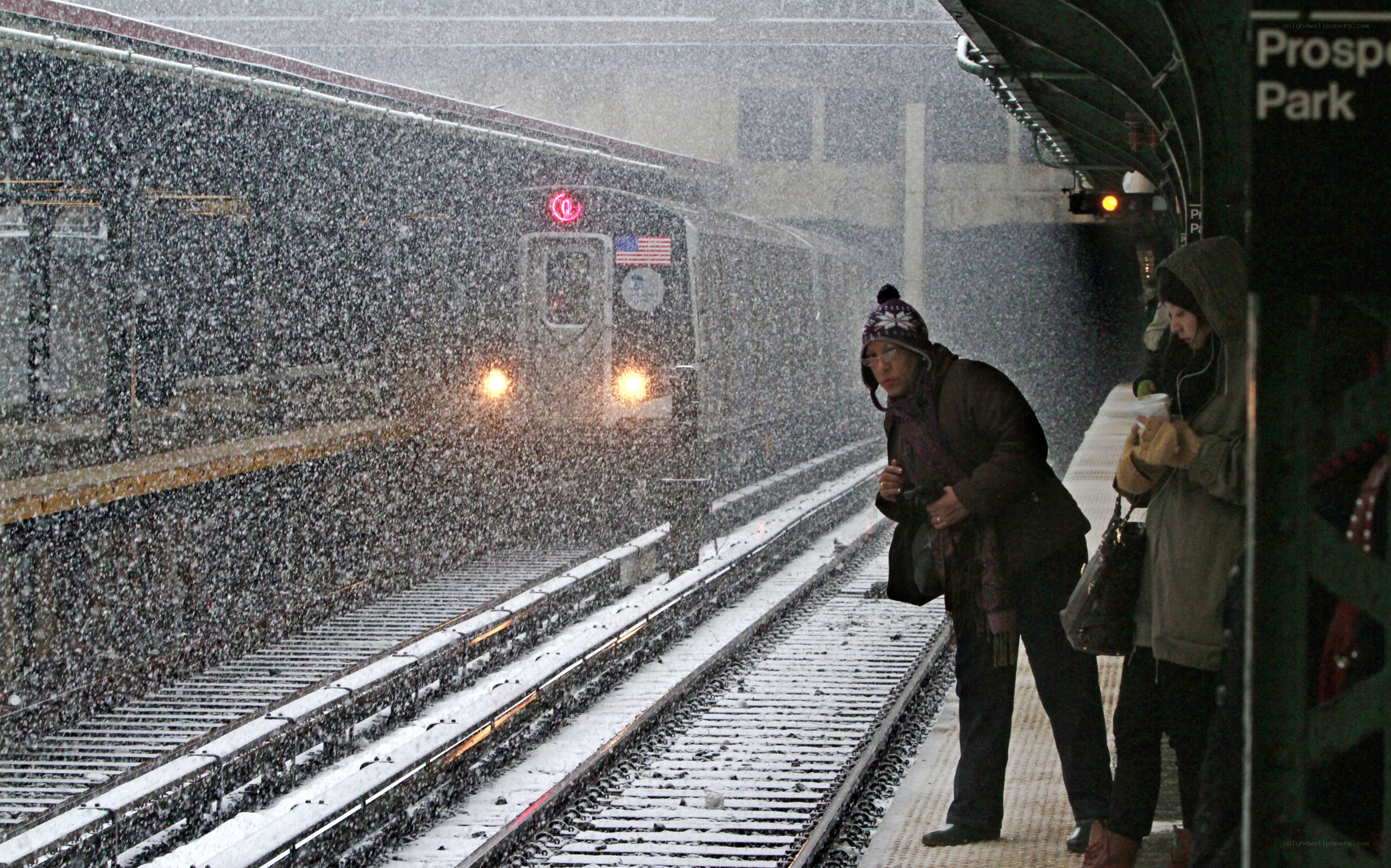 People waiting for train in snow