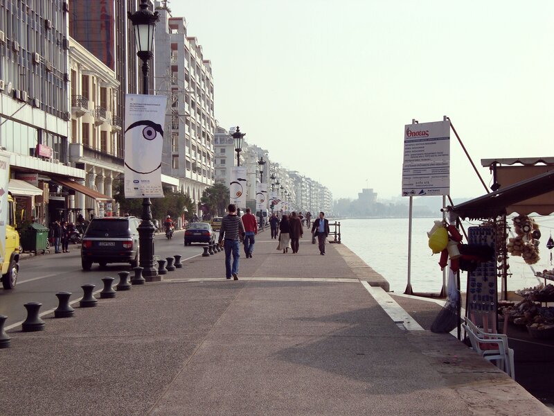 People walking along a waterfront promenade