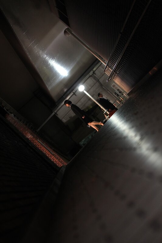 People walking in a dimly lit alley