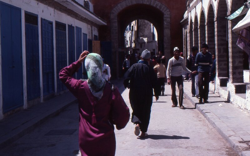 People walking in a narrow alley