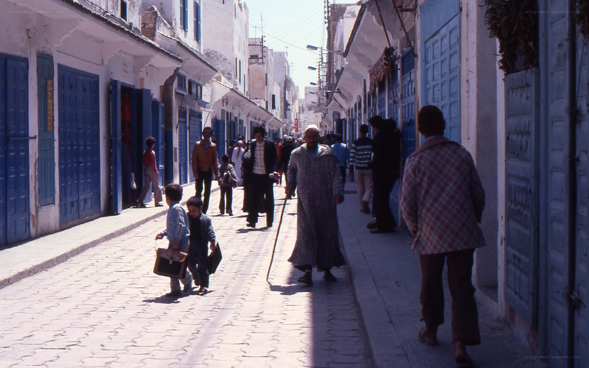 People walking in a narrow street