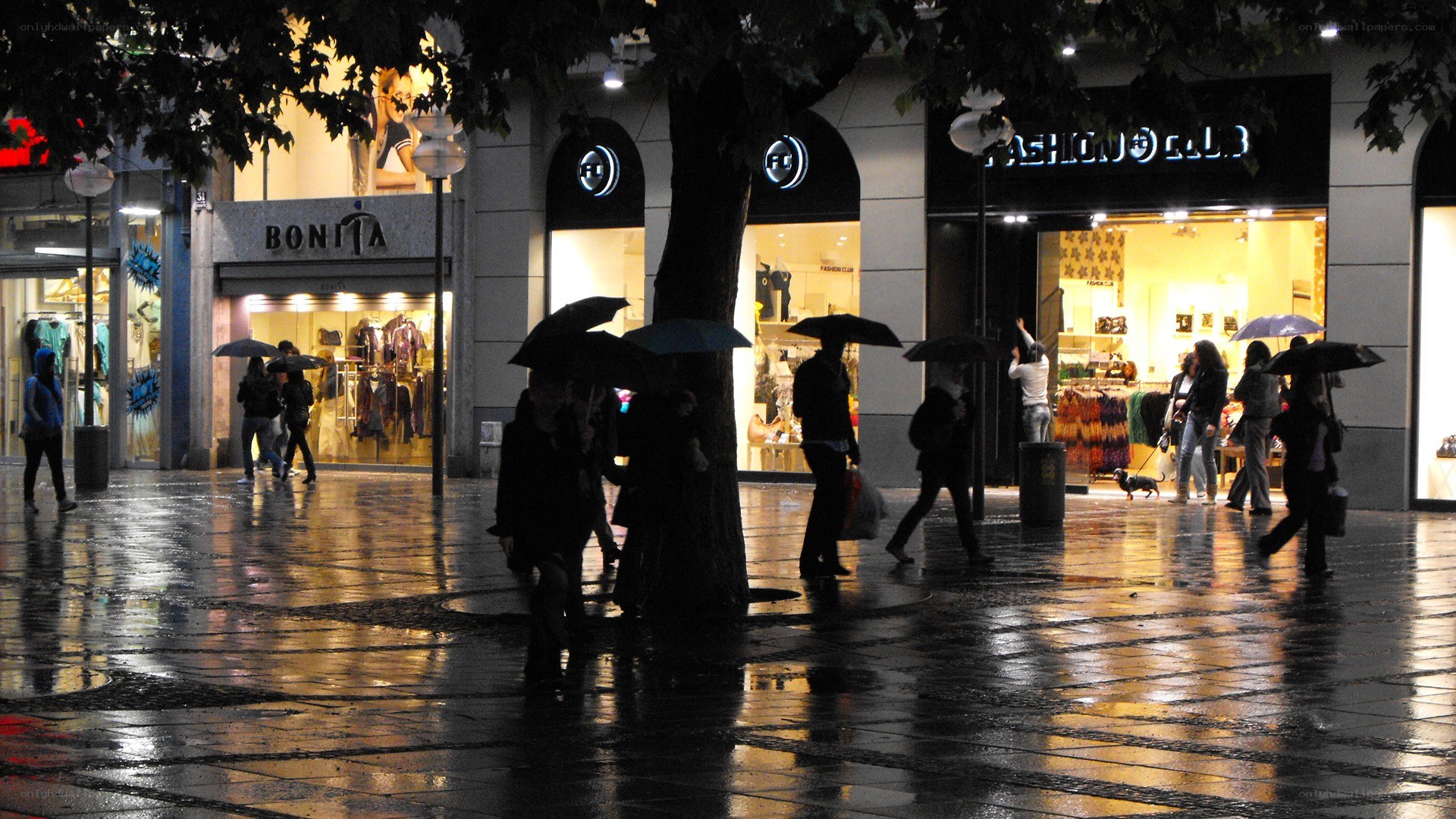People walking in rain at night
