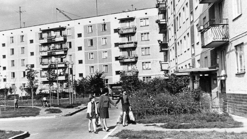 People walking near apartment buildings