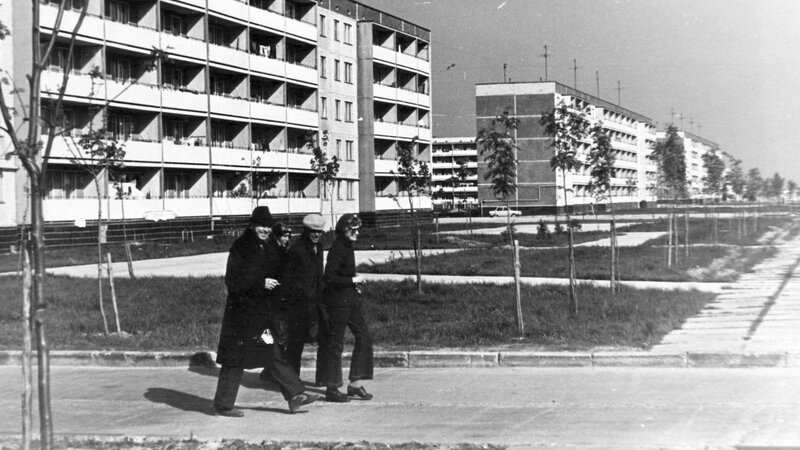 People walking near apartment buildings