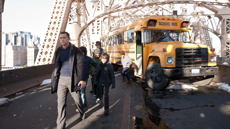 People walking on a bridge with a school bus