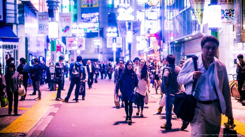 People walking on a busy street at night