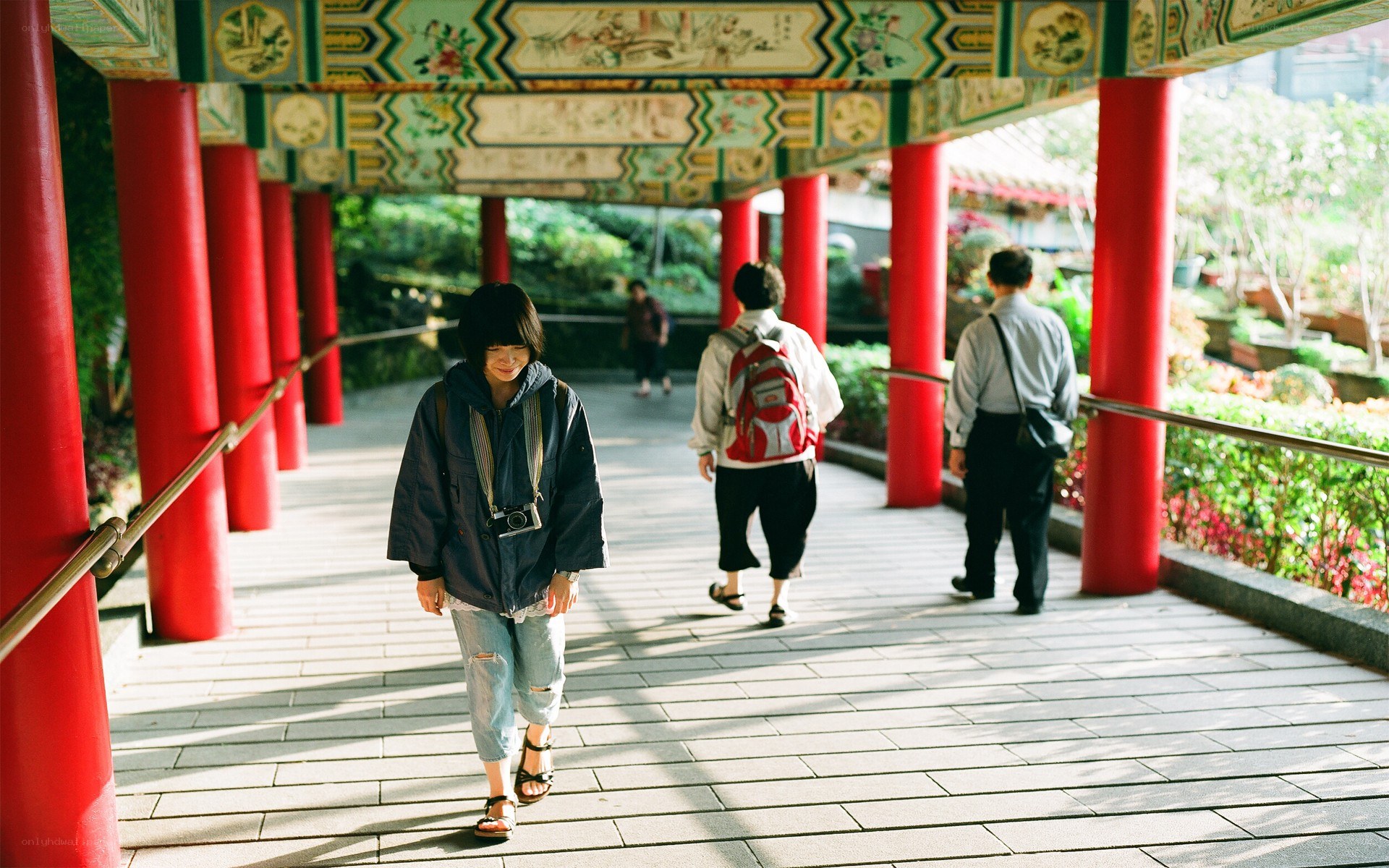 People walking on a covered walkway