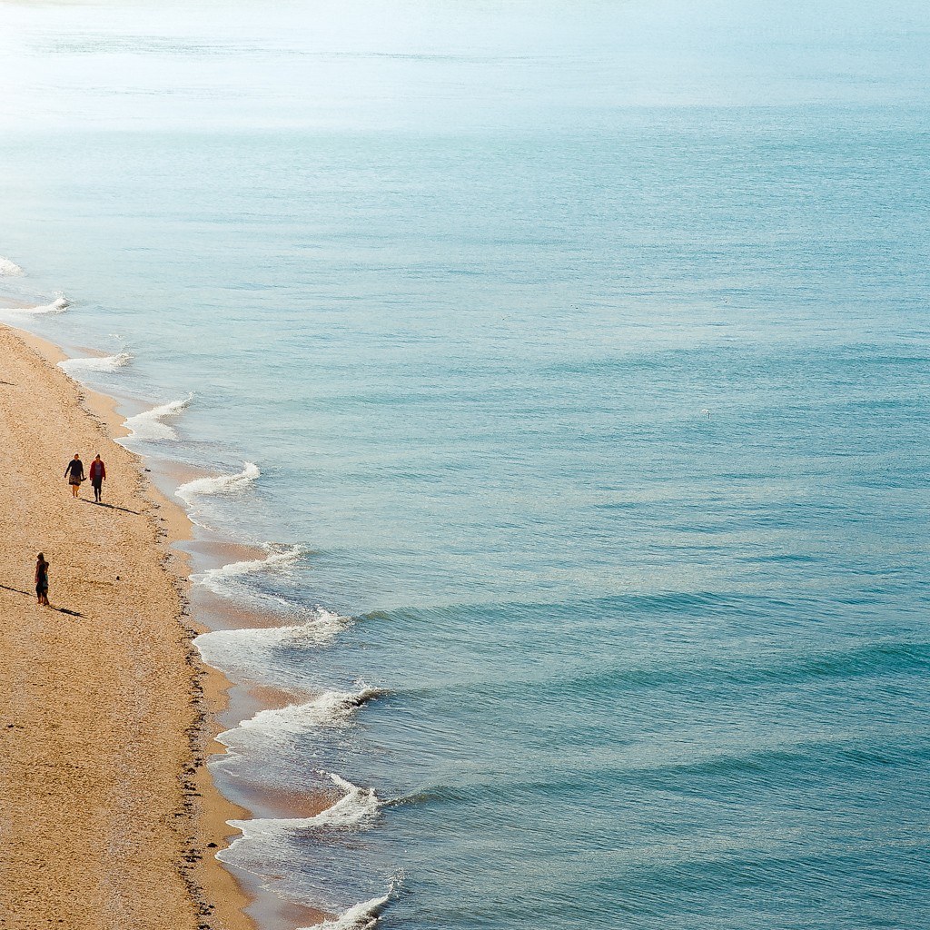 People walking on a sandy beach