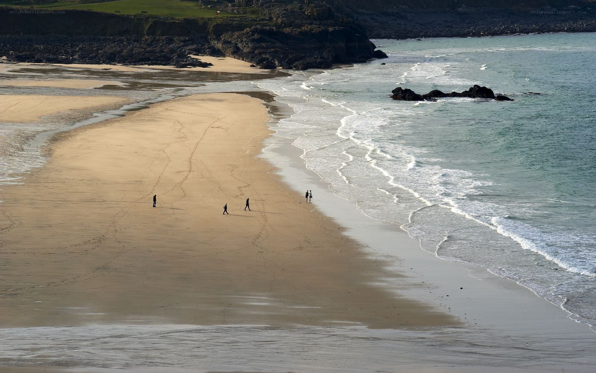 People walking on a sandy beach