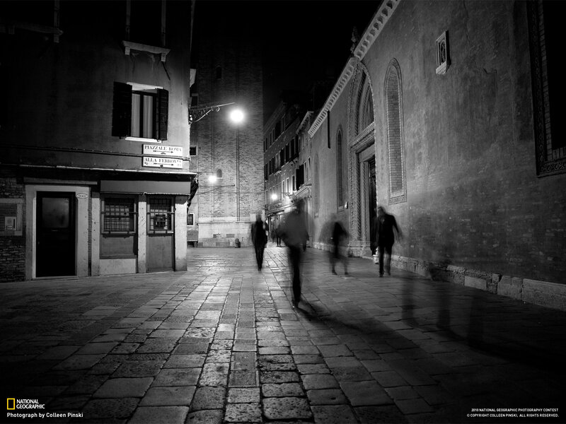 People Walking on Cobblestone Street