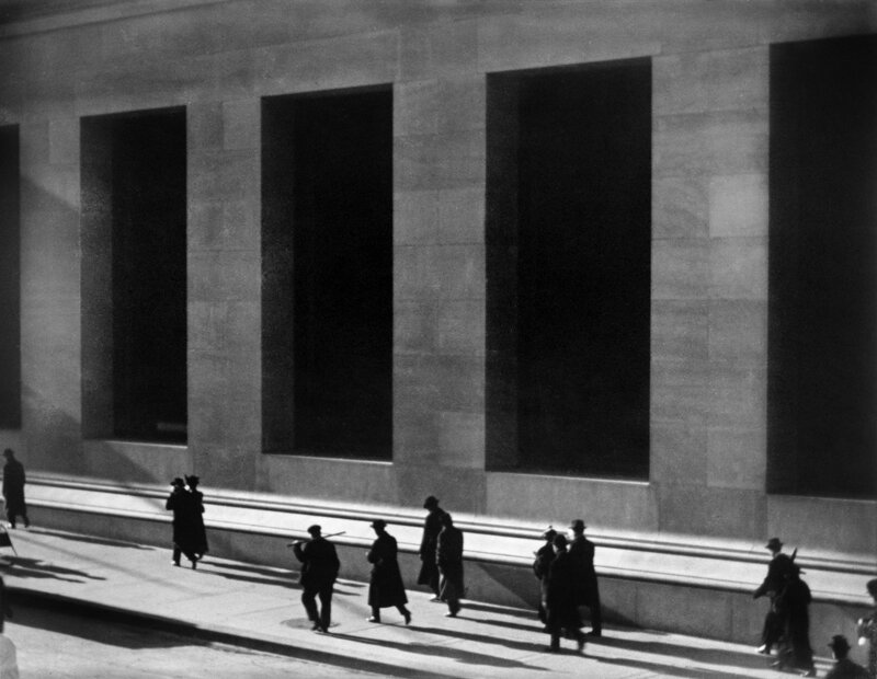 People walking past a building