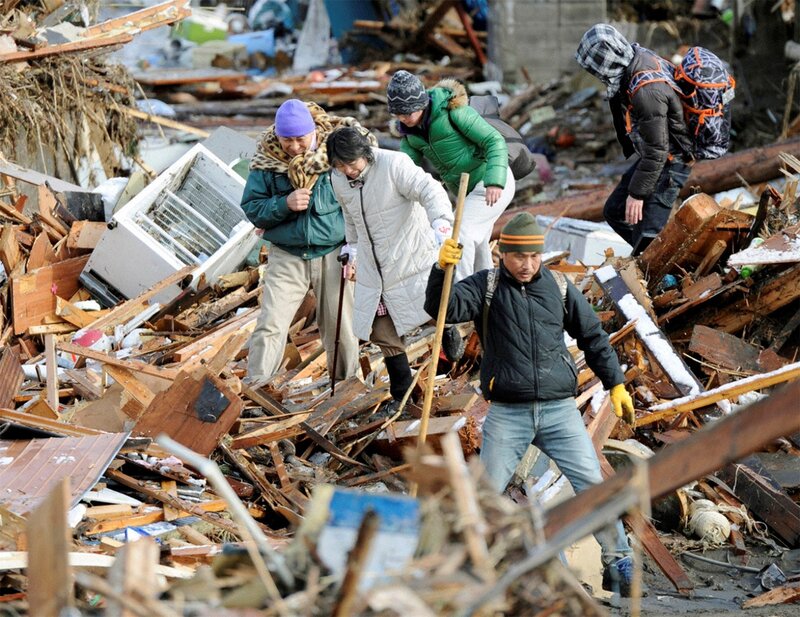 People Walking Through Debris