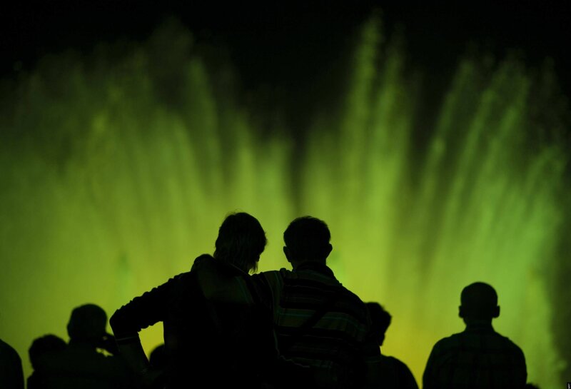 People watching a green fountain