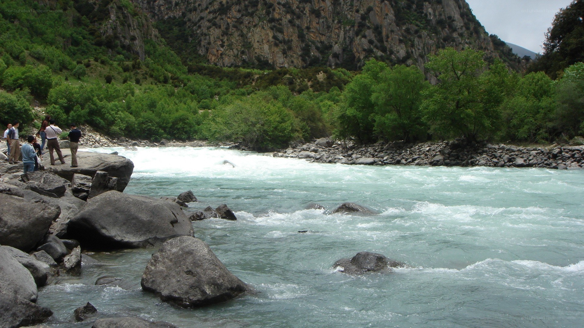 People watching a river rapids