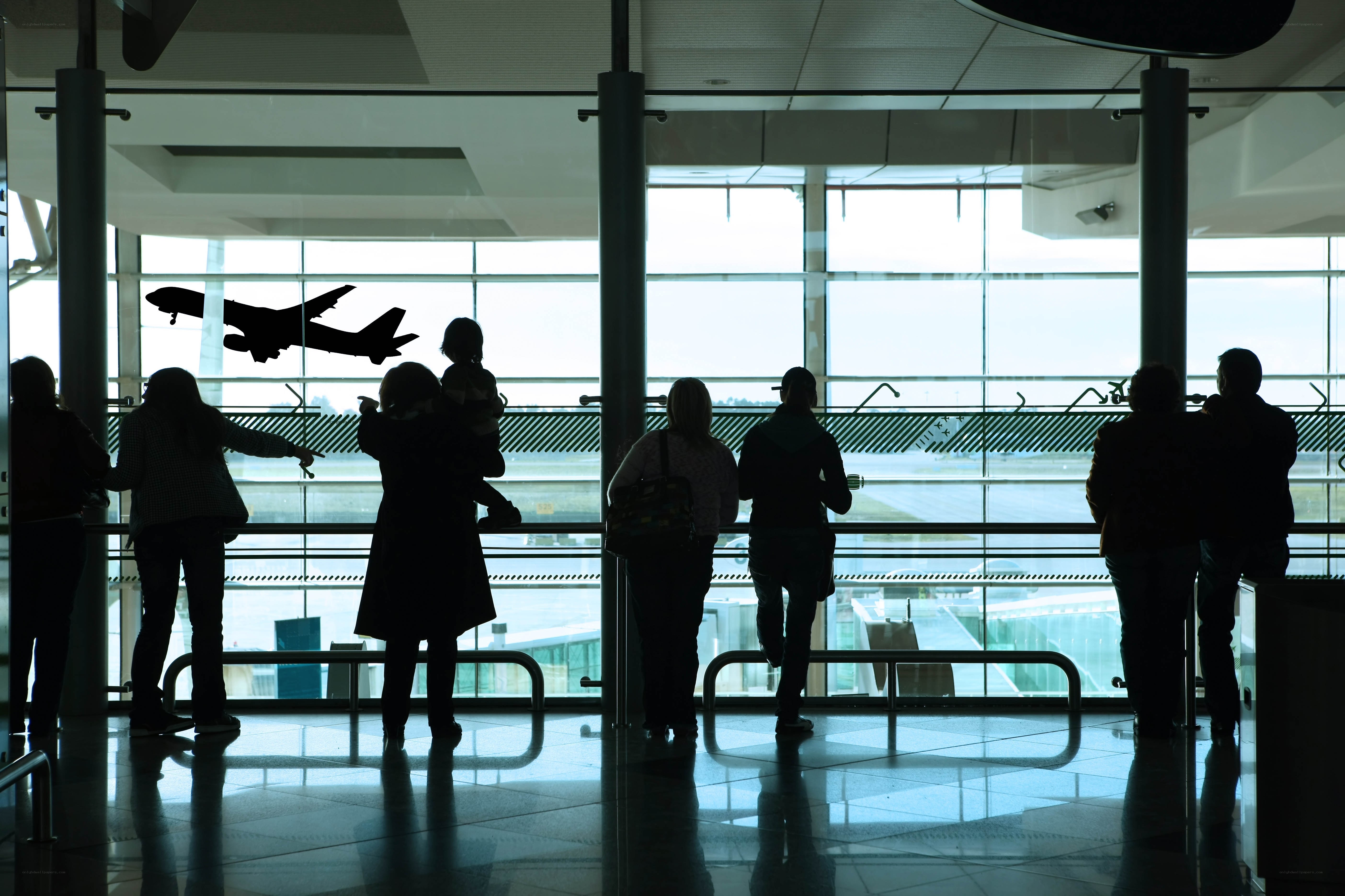 People watching plane at airport