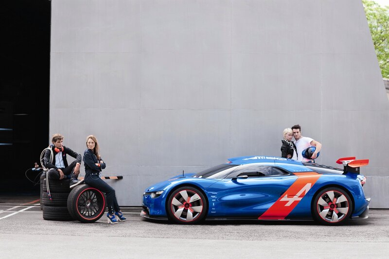 People with a blue race car