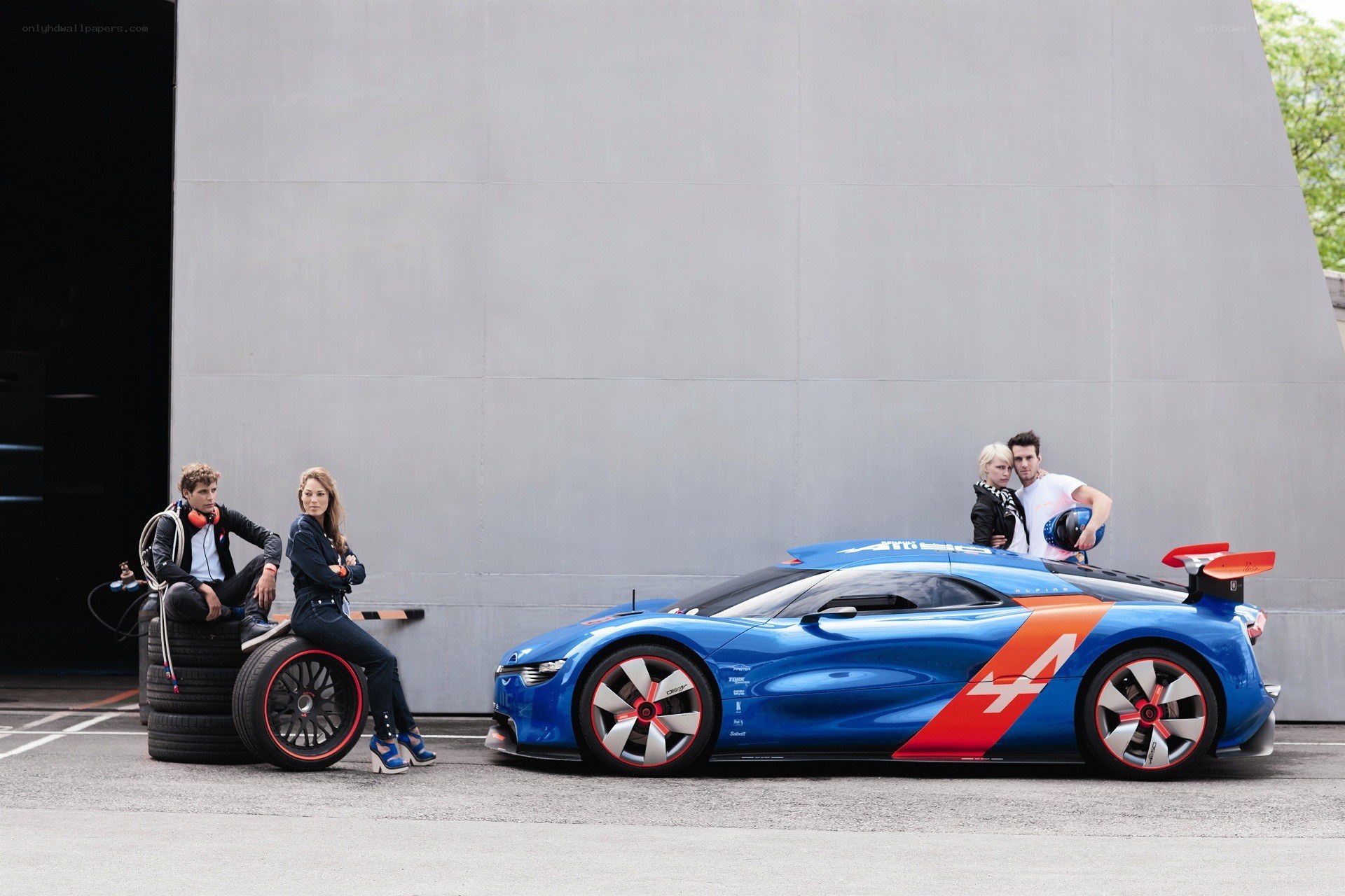 People with a blue race car