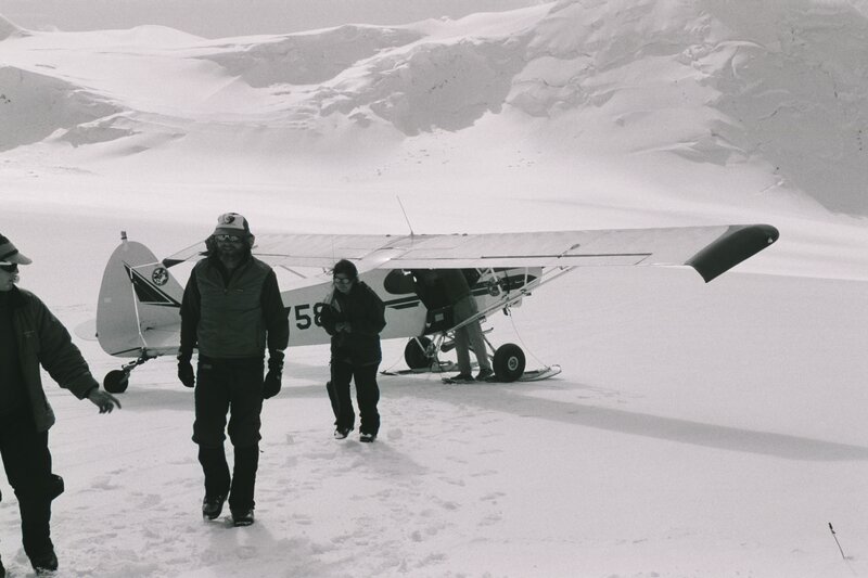 People with a plane in the snow