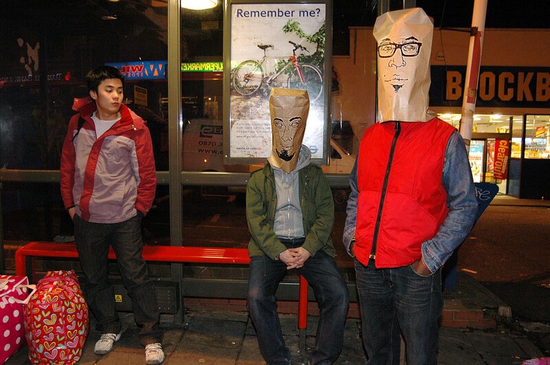 People with paper bags on heads