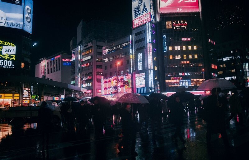 People with Umbrellas at Night — Black