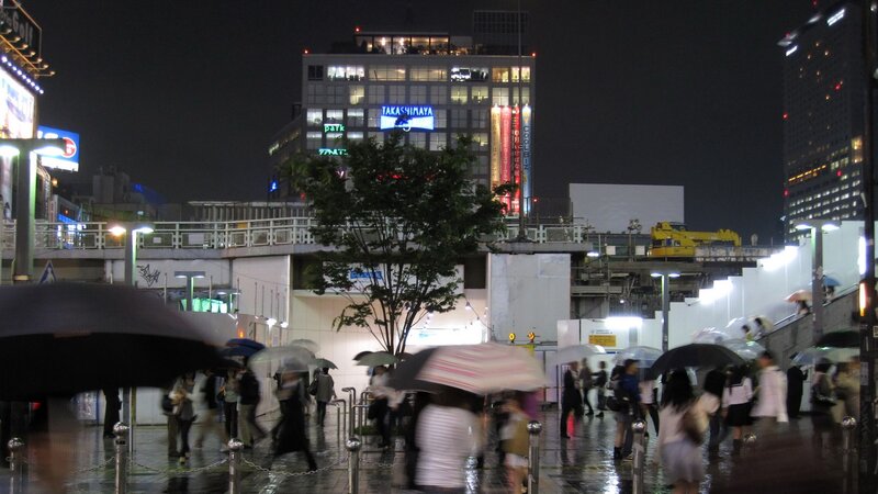 People with umbrellas in rainy city